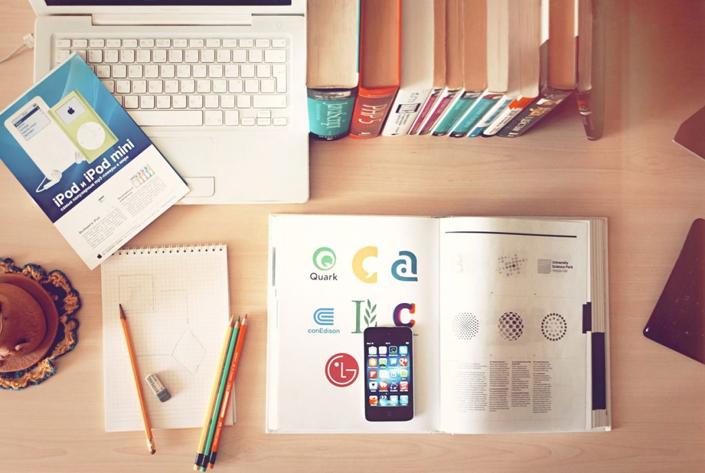 pencils-and-phone-on-top-of-books.jpg